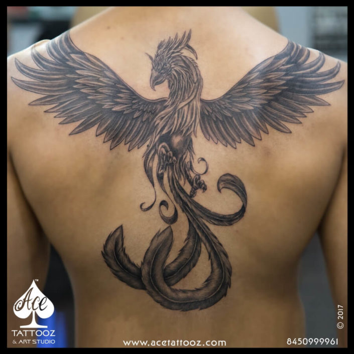 Back tattoo of a phoenix by Murat Bilek.