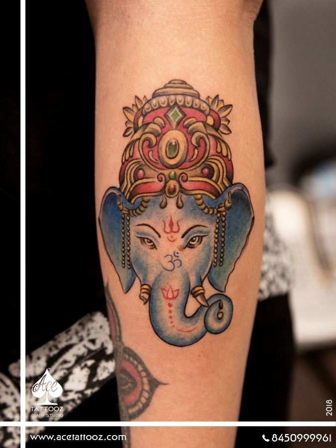 Ganesha Face Tattoo on Forearm