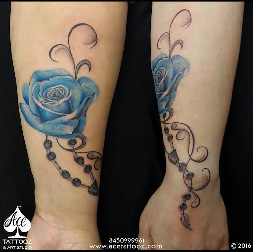AI Image Generator Tattoo design that has 2 blue roses on the shoulder and  thorns coming out of it down the arm