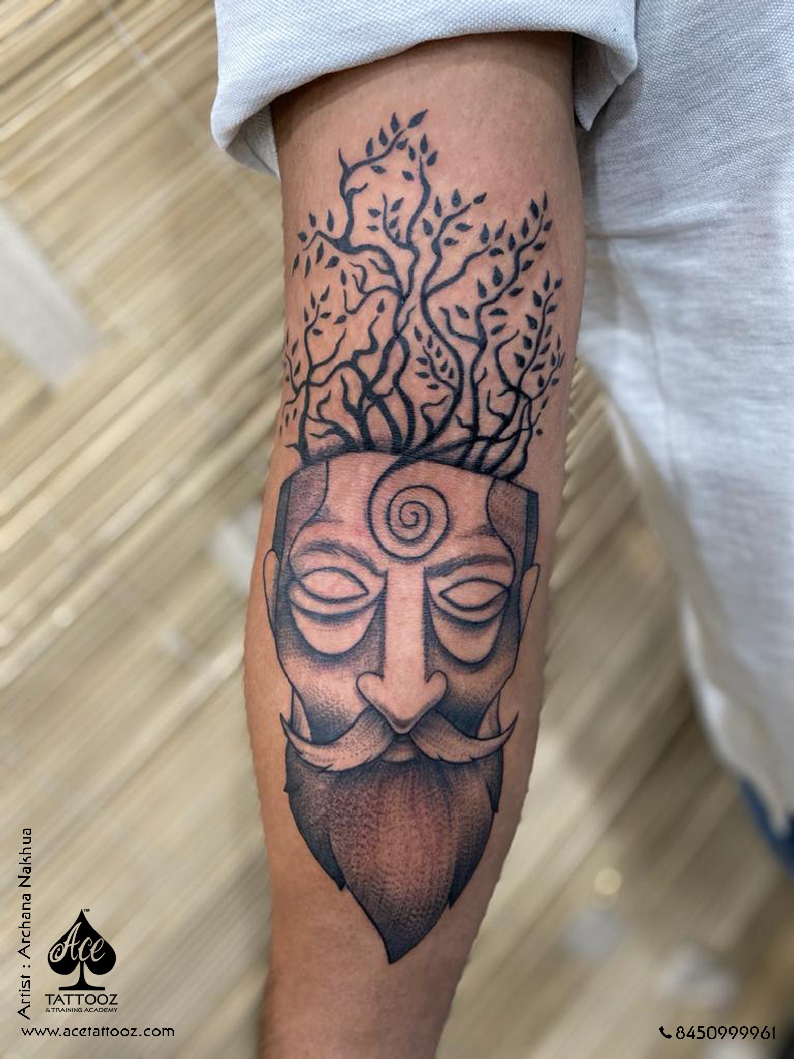 Fine line pine tree tattoo located on the upper arm,