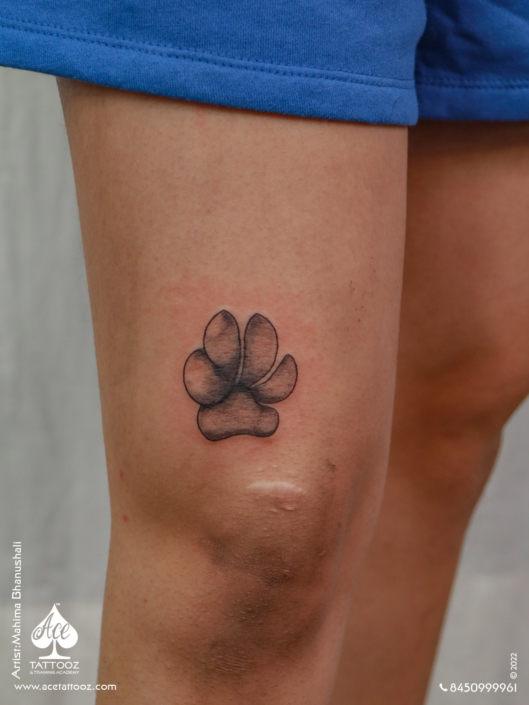 Black and white Dog Paw tattoo - Ace Tattoos