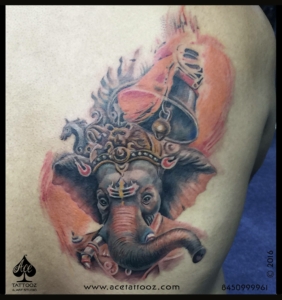 colorful Ganesha tattoo with a temple bell