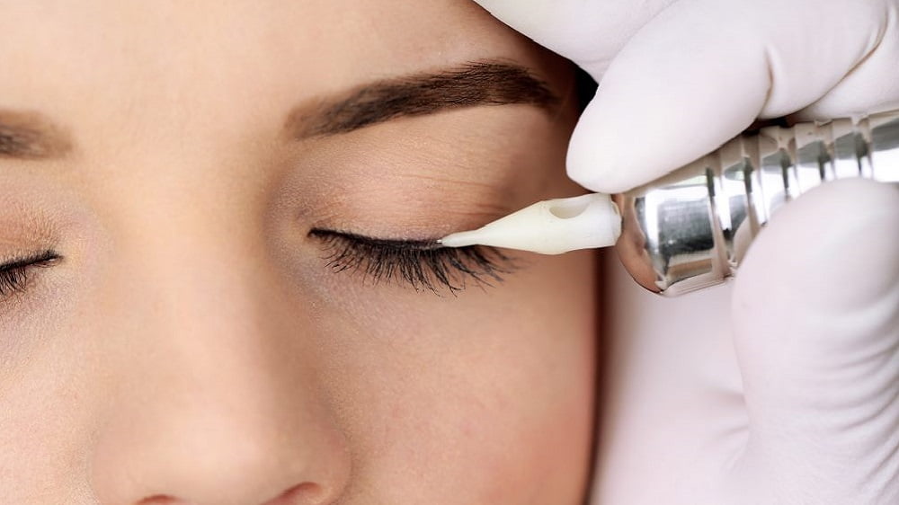 Cosmetologist making permanent makeup, close up