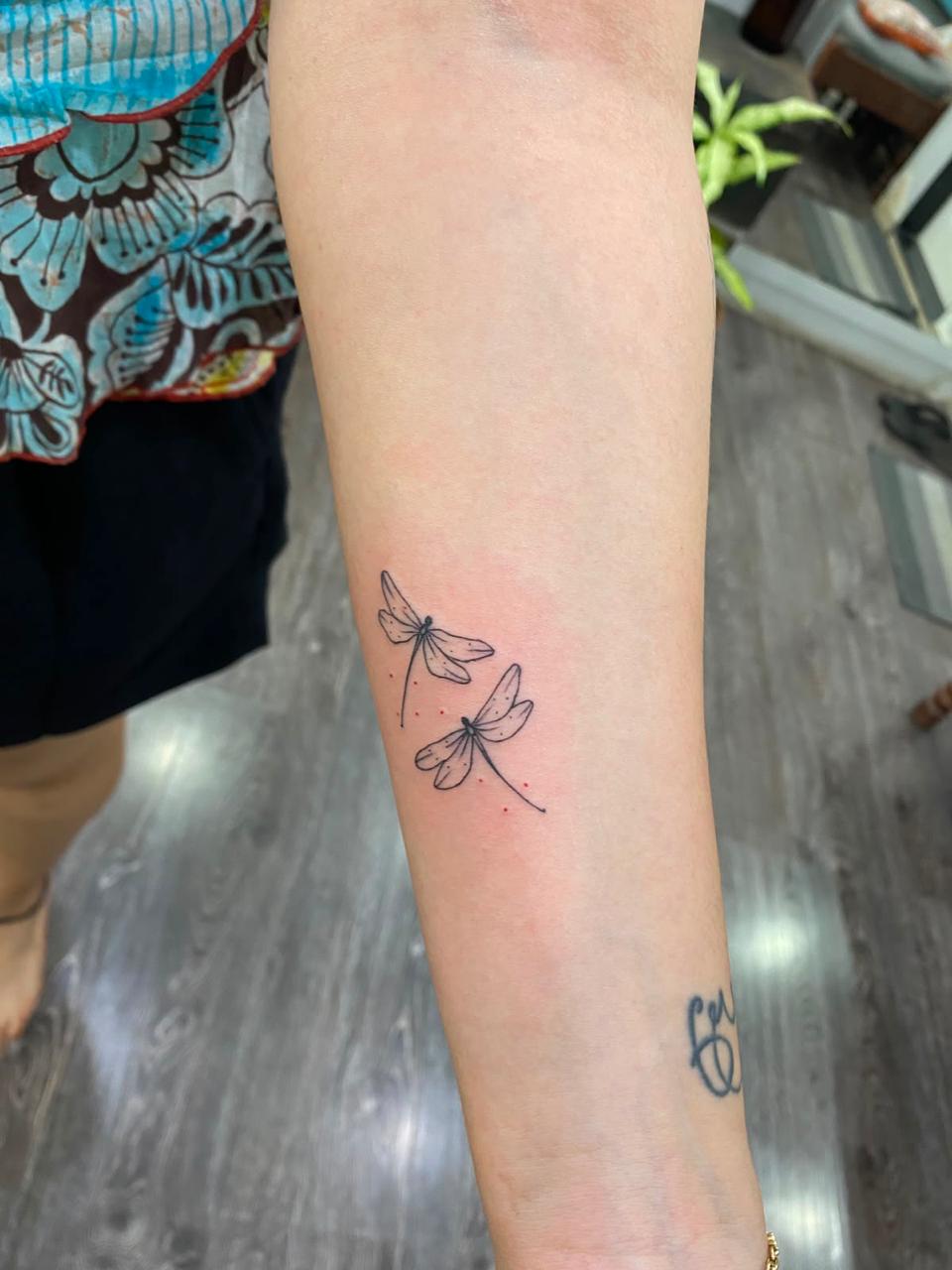 Fine-line Vakratunda Ganesha tattoo on a hand