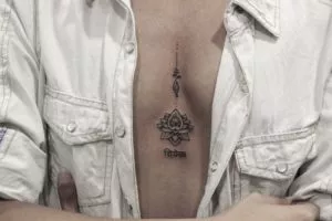 sternum-tattoo-with-lotus-tattoo-enlightenment-symbol