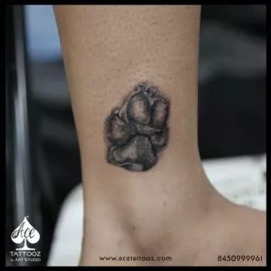 paw tattoo on leg - Ace tattoos