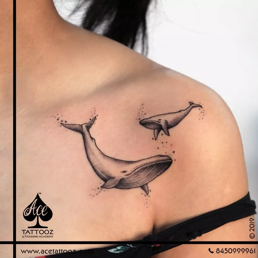 Minimalistic whale tattoo located on the inner forearm