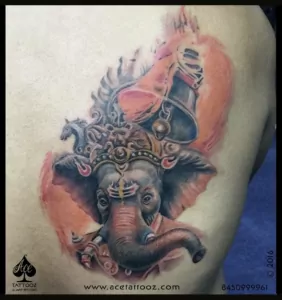 colorful Ganesha tattoo with a temple bell